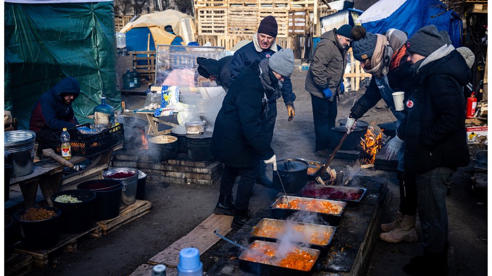 Volunteers prepare food for local residents and members of the Ukrainian Territorial Defence Forces at a field kitchen in Kyiv on 11 March 2022.