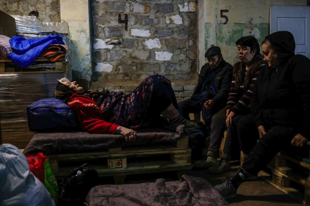 SEVERODONETSK, UKRAINE - 2022/05/23: An injured woman lays on a wooden pallet inside the center for distribution of humanitarian aid in Severodonetsk.