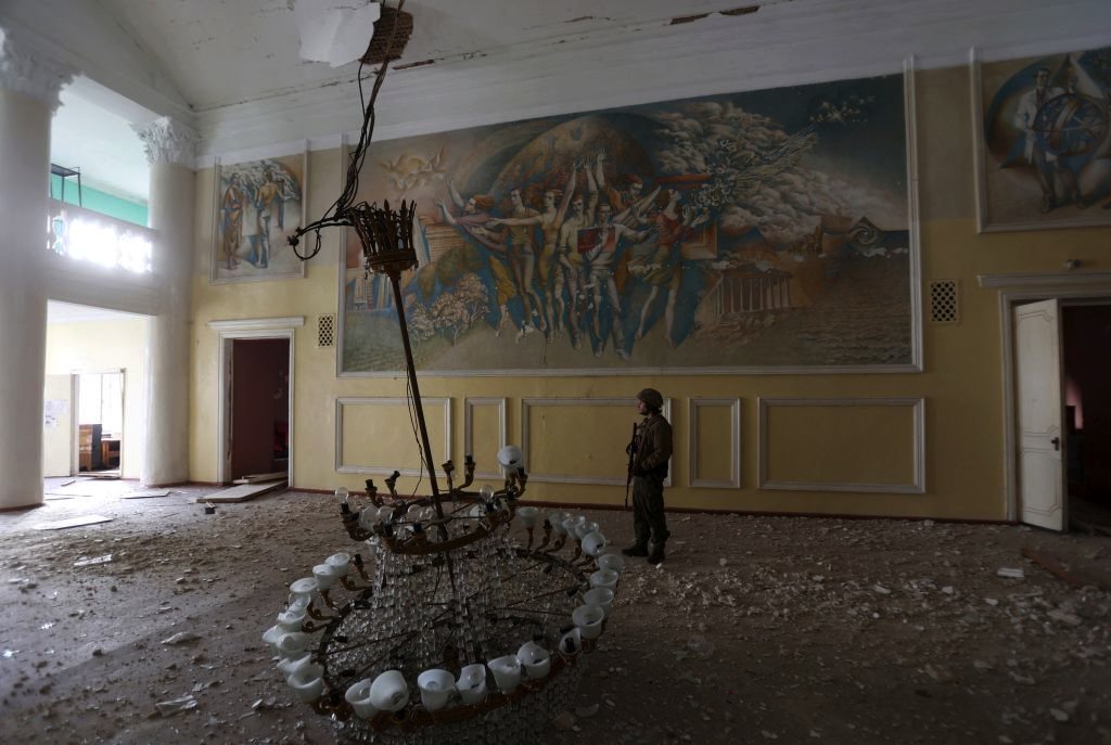 A Ukrainian serviceman stands in a hall at a damaged local cultural centre, in the town of Rubizhne, Luhansk region, on April 8, 2022
