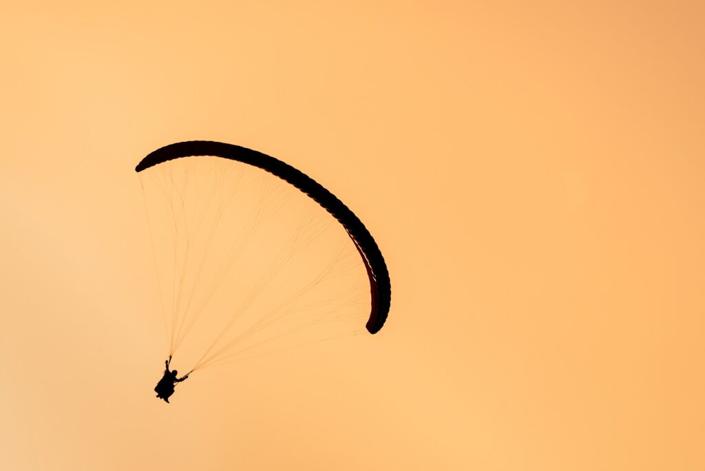 silhouette of paraglider tandem flying in orange s 2021 08 26 17 00 57 utc новости Гудаури