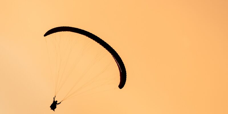 silhouette of paraglider tandem flying in orange s 2021 08 26 17 00 57 utc новости Гудаури