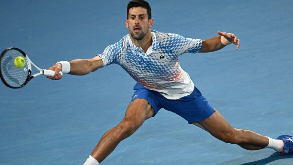 Novak Djokovic stretches for a ball in the Australian Open final against Stefanos Tsitsipas