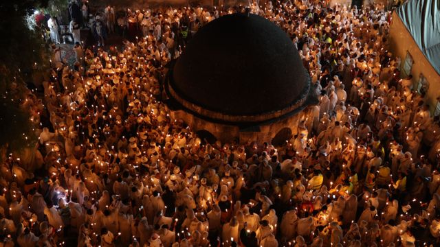 Ethiopian Orthodox Christian pilgrims hold candles during the Holy Fire ceremony