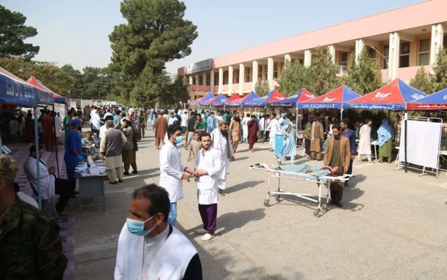 Doctors and paramedics treat the injured earthquake survivors in front of the Herat Regional Specialized Hospital 
