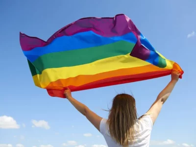 depositphotos 301588168 stock photo rear view woman rainbow flag ЛГБТ ЛГБТ